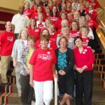 MNA Team2 A group of nurses stand together wearing red.
