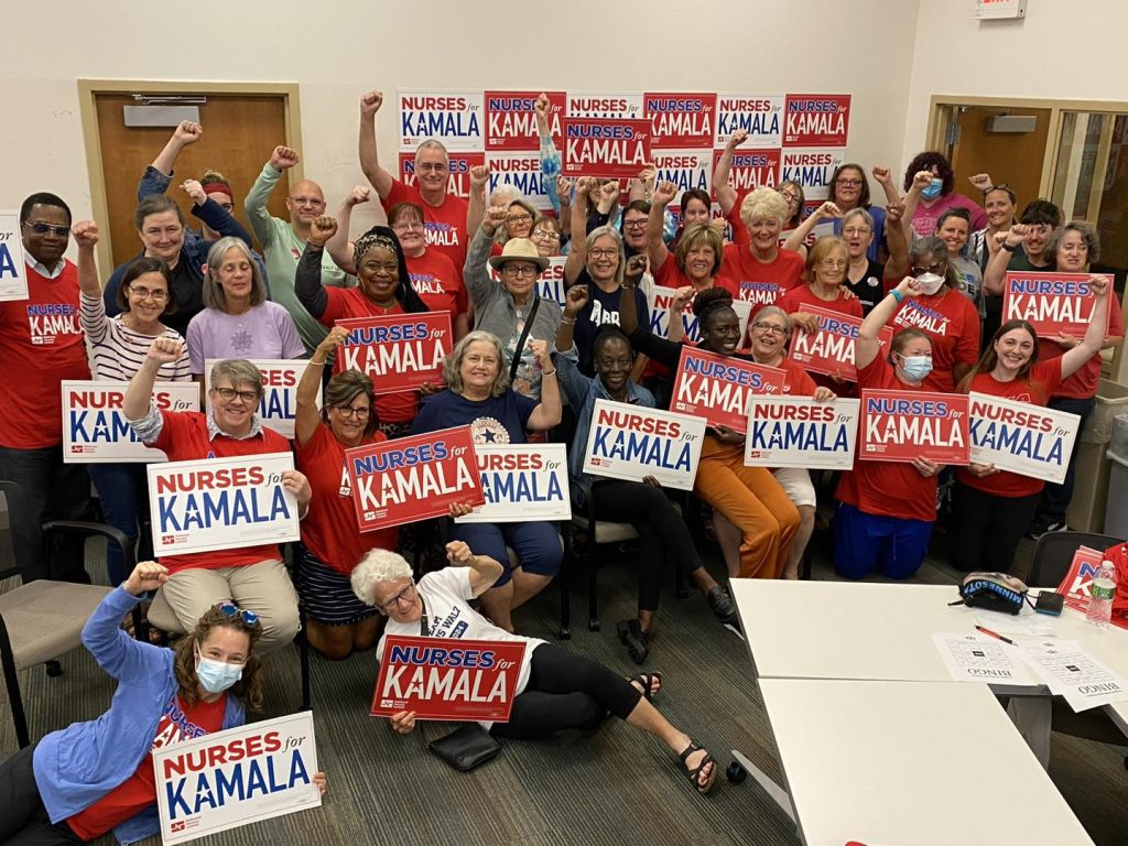 Power in numbers: room of nurses holding up Kamala signs