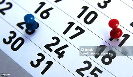 Calendar with pushpins on certain dates