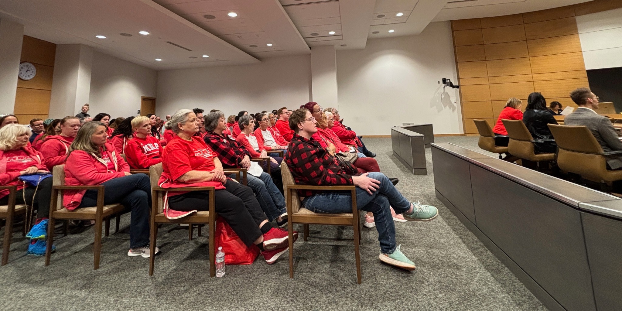Nurses wearing MNA red t-shirts fill a legislative committee hearing room.