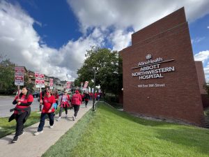 Allina Health Abbott Northwestern Hospital with nurses picketing outside.