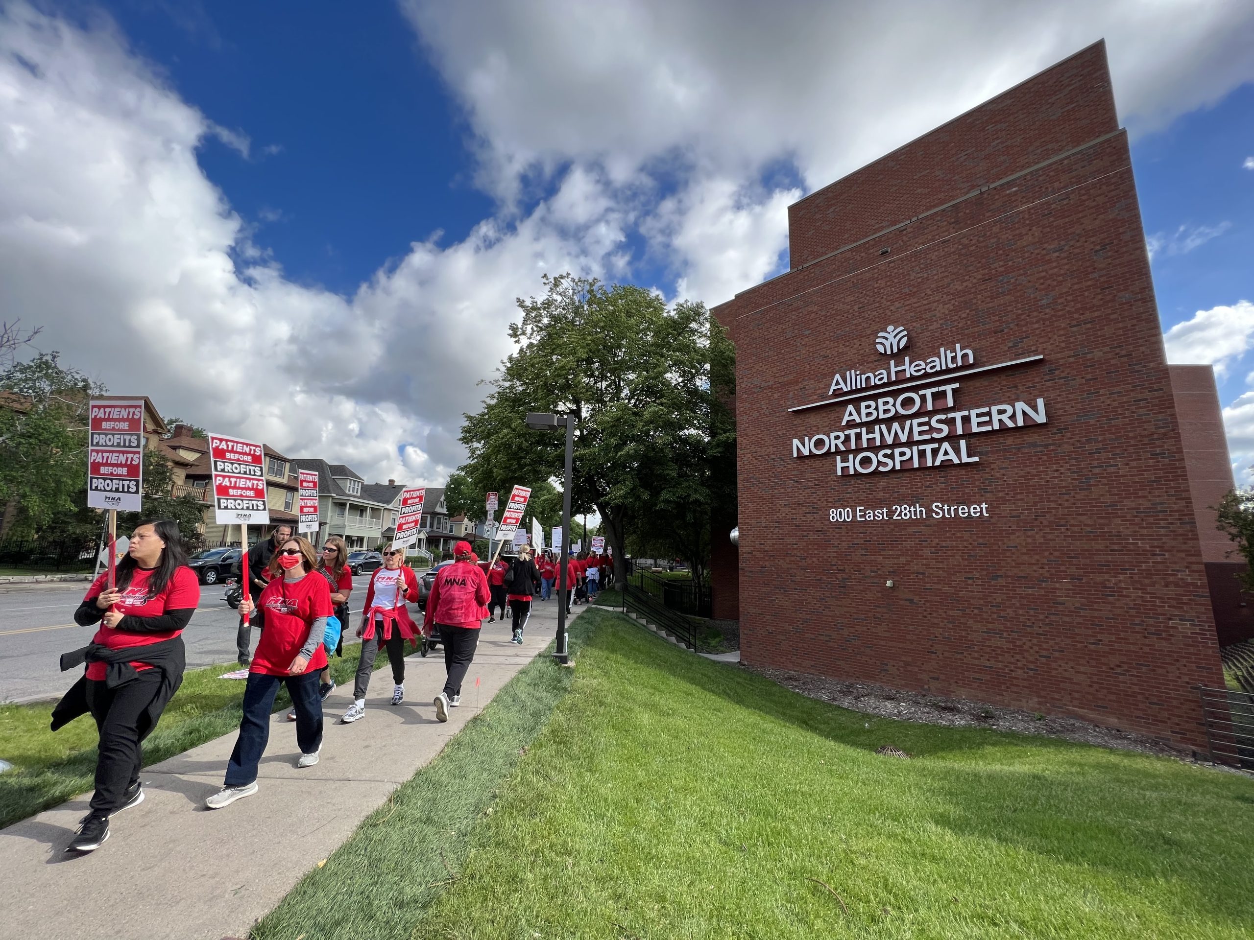 Allina Health Abbott Northwestern Hospital with nurses picketing outside.
