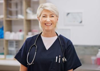 Smile, mature and woman with portrait in vet for professional career in animal care, welfare and wellness. Female veterinarian, pet doctor and specialist with pride for expert support in healthcare.